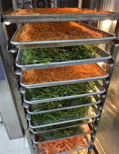 Surplus vegetable trimmings being dehydrated in the teaching kitchen